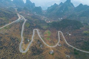 Aerial view of winding motorbike roads through karst mountains in northern Vietnam
