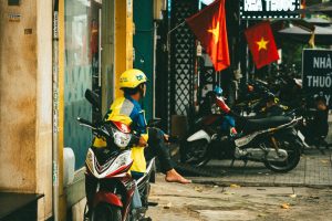 A traveller on a rented scooter parked on a Vietnam street